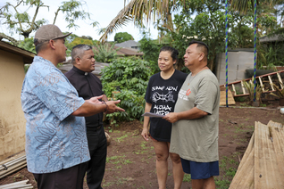 Knights speak with Josephine and Fredrick Diana, whose home in Waialua, Hawaii, was damaged by floodwaters. 