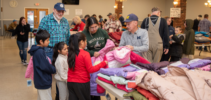 Members of Monroe (Mich.) Council 1266 help a local family select new winter jackets during the council’s annual Knights of Columbus Coats for Kids event. 