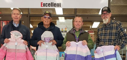 Members of Sacred Heart of Mary Council 7622 in Jermyn, Pa., and St. Padre Pio Assembly 2768 hold coats with Kevin Sullivan (second from right), principal of Lakeland Elementary School – Mayfield Campus, at the school. The Knights donated nearly 50 coats through the Knights of Columbus Coats for Kids program to the school and Catholic Social Services in Carbondale.
