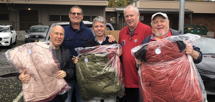 Members of Msgr. Charles P. Taaffe Council 14802 in Beaverton, Ore., hold up some of the more than 70 coats donated by the council through the Knights of Columbus Coats for Kids program. 
