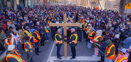 Knights from Msgr. Doyle Council 1186 in Calgary, Alberta, hold a cross during an outdoor Way of the Cross procession organized by the council in partnership with Sacred Heart Parish and the Diocese of Calgary. 