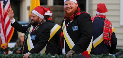 Matt Sennett (left) and Connor Graff of Bel Air Council 4714 in Forest Hill, Md., lead a K of C float during the annual Christmas parade in Bel Air. Knights from Council 4714 and Havre de Grace Council 2002 in Aberdeen participated in the parade, which drew more than 20,000 attendees. Knights also distributed recruitment materials at a tree-lighting event in Shamrock Park following the parade.
