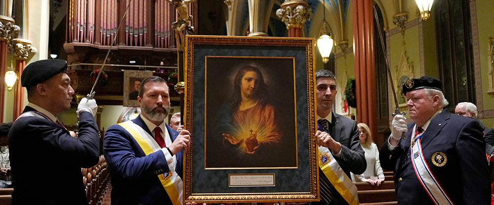 Iaian Blamey (left), manager of life and faith programs for the Knights of Columbus, and Grand Knight Drew Dillingham of San Salvador Council 1 in New Haven, Conn., process with the Sacred Heart pilgrim icon during a Mass and Holy Hour at St. Mary’s Church on Jan. 3. 