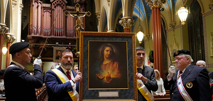 Iaian Blamey (left), manager of life and faith programs for the Knights of Columbus, and Grand Knight Drew Dillingham of San Salvador Council 1 in New Haven, Conn., process with the Sacred Heart pilgrim icon during a Mass and Holy Hour at St. Mary’s Church on Jan. 3. 