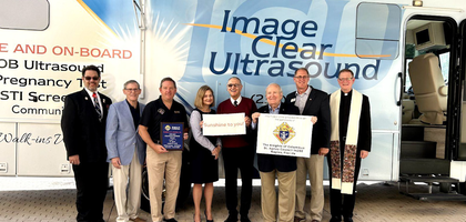 Several Florida Knights, including state council officers and Grand Knight Jerry McGrath (second from left) of St. Agnes Council 14202 in Naples, are joined by CEO Scott Baier (second from right) of Community Pregnancy Clinics in front of a new mobile ultrasound van funded by Council 14202 for the clinics. 