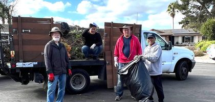 Knights from Good Shepherd Council 9076 in San Diego assemble in front of a truck filled with tree trimmings and weeds collected during a council service day. 