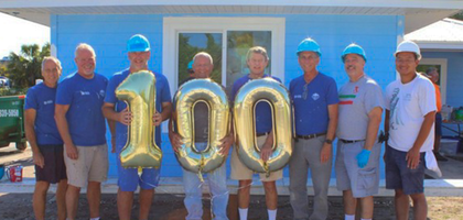 Knights from Sts. Cosmas and Damian Council 13341 in Lakewood Ranch, Fla., stand in front of a home they recently refurbished as they celebrate their 100th consecutive month of service with Manatee County Habitat for Humanity.