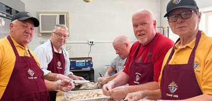 Knights from Belle Vernon Council 3026 in Yukon, Pa., carve turkeys for an Epiphany dinner organized by Seven Dolors Parish’s Christian Mothers and Ladies.