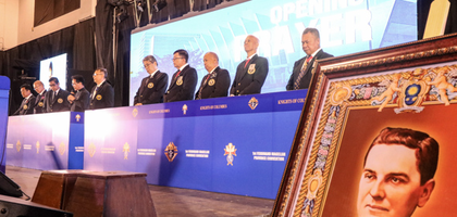 Knights of Columbus leaders in the Philippines bow their heads in prayer during the business session of a Fourth Degree convention.