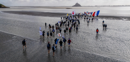 Carrying the flags of their country, the Vatican and the Order, Knights in France embark on an 8-mile walk across the shallow bay between the Normandy coast and Mont Saint-Michel, home to the Catholic abbey of the same name.