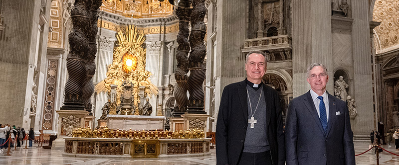 Cardinal Mauro Gambetti, archpriest of St. Peter’s Basilica and president of the Fabbrica di San Pietro, and Supreme Knight Patrick Kelly stand in front of the Bernini baldacchino in St. Peter’s Basilica in Vatican City on Jan. 10. 