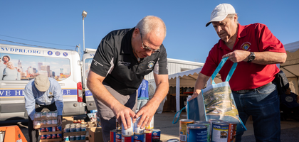 Rhode Island State Deputy Joseph Carrignan (left) and District Deputy Steven Perry prepare boxes of food during a Holiday Harvest of Hope event organized by the Rhode Island State Council and the Society of St. Vincent de Paul. 