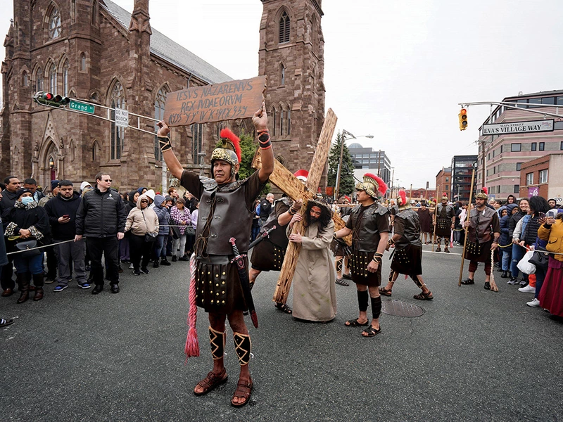 Members of Cathedral of St. John the Baptist Council 17254 in Paterson, N.J., participate in the council&rsquo;s annual Via Crucis procession through downtown Paterson.