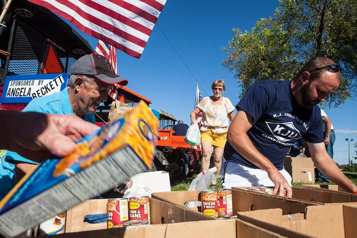 Knights place food in boxes outdoors.