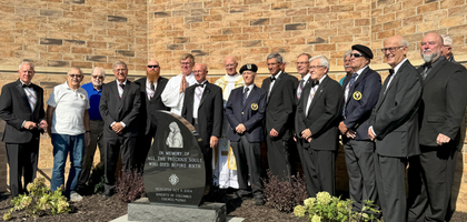 Members of Corpus Christi Council 12960 in Lawrence, Kan., assemble behind a new memorial to unborn children purchased by Council 12960 for Corpus Christi Parish.