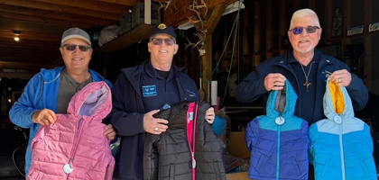 Knight Fred Lyon and Deputy Grand Knight Robert McManus of Father Vernon J. Sierminski Council 8043 in Sanford, Mich., display some of the children’s jackets purchased by the council through the Knights of Columbus Coats for Kids program.