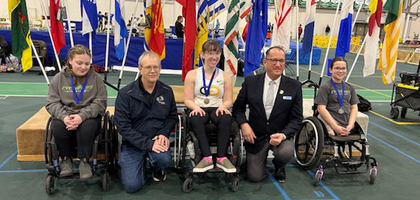Past State Deputy Larry Packet (second from right) of Saskatchewan gathers with Special Olympics athletes during the 58th Annual Knights of Columbus Indoor Games in Saskatoon.
