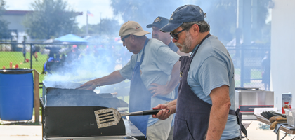 Members of St. John of The Cross/Our Lady of the Rosary Council 13153 in Vero Beach, Fla., prepare food during a Special Olympics Florida regional competition. 