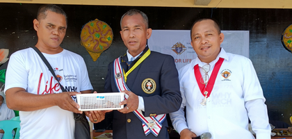 Knights from Visayas District #44 present Arnulfo Saguindan (left), a brother Knight, with a donation of 6,700 PHP (about $120) to help with the cost of an operation for his wife. 