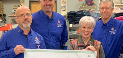 Members of St. Patrick Council 3484 in Canby, Oregon, present a ceremonial check to Patti Serres, executive director of Bloomin’ Boutique, representing the council’s donation of over $31,000 to purchase clothes for children in need. 