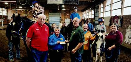 Grand Knight Robert Marande (left) and Deputy Grand Knight Bill Bissinger Jr. of Father Arthur J. McCann Council 2290 in Bloomsburg, Pa., present a $1,600 check to Deb Smith, founder of Eos Therapeutic Riding Center, which provides horseback activities for people with disabilities. The council has donated more than $23,000 to the organization over the past 20 years.
