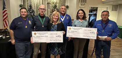Grand Knight Kevin Kennedy (right) and other officers of Columbian Council 2191 in Batavia, Ill., present $9,000 checks to Jeanna Desideri (second from left) and Julie Garofalo, executive directors of Corbella Clinic and Waterleaf Women’s Center, respectively. The council has supported both pregnancy resource centers for more than a decade; proceeds for the donation came from its golf fundraiser.