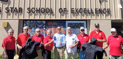 Members of Father Michael Cottrell Council 7672 in Grove City, Fla., and Father Stanley S. Kromer, O.Carm Council 11553 in Englewood present a check for more than $1,200 to Principal Eric Idoyaga of Englewood Elementary School to purchase coats for students in need.  Together, the councils raised more than $5,800, funding about 500 coats for students at three local schools.