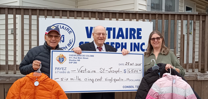 Grand Knight Léo-Paul Babineau (center) and Past Grand Knight Guy Lavigne of Rev. Père Donat LeBlanc Council 7334 in Shediac, New Brunswick, present a check for more than CA$6,500 to Heather Richards, director of Vestiaire St. Joseph Store, a thrift store that supports the attached food pantry. The funds were used to purchase 120 coats for people in need.