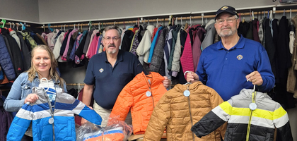 Grand Knight Jim Gorghuber (center) and Financial Secretary Doug Rivers of Ave Maria of the Runestone Council 4718 in Alexandria, Minn., present about 50 coats to Jen Jabas, executive director of United Way Lakes and Prairie, for distribution to local children and adults in need. This was the fifth year the council participated in the Knights of Columbus Coats for Kids program, donating about 200 coats in that time.