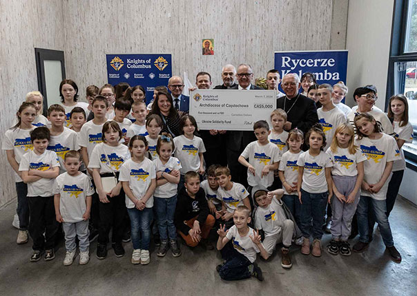 Polish Knights, including Supreme Warden Andrzej Anasiak and State Chaplain Archbishop Wacław Depo of Częstochowa, present a donation of CA$5,000 from Ontario Knights at the orphanage for Ukrainian children.