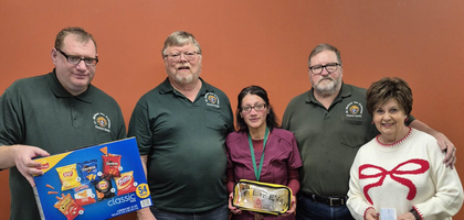 Members of St. Michael the Archangel Council 15458 in Canton, Ohio, present a box of chips, an anti-choking LifeVac kit and a $2,000 check to Principal Claire Gatti (right) and nurse Michelle Diaz of St. Michael the Archangel School. The proceeds provided financial support to students in need. The snacks, which the council has provided periodically for more than two years, are given to students who do not have one for the day.
