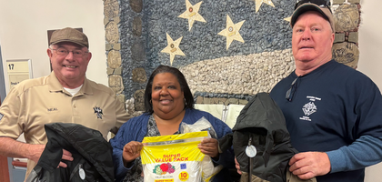Faithful Captain Neal Potts (left) and Brian Gallagher of Bishop Thomas J. Mardaga Assembly 2014 in Claymont, Del., display donations from the assembly’s annual clothing drive with Sonya Thomas, a staff member at the Wilmington VA Medical Center. The assembly distributed more than 2,000 items — including clothing and toiletries — to local VA medical centers and other organizations supporting veterans.
