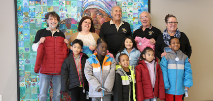 Members of St. Maria Goretti Council 12836 in Edmonton, Alberta, present staff and students from St. Teresa of Calcutta Catholic Elementary School with two dozen new winter jackets from the Knights of Columbus Coats for Kids program. 