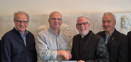 Knights from St. Christopher Council 4788 in Edmonton, Alberta, present a CA$200,000 check to Father Sylvain Casavant, rector of St. Joseph Seminary and a brother Knight, to support the Foundation of St. Joseph Seminary and Newman Theological College. The proceeds — from the sale of the council’s home corporation building — were used to start a scholarship fund for seminarians.