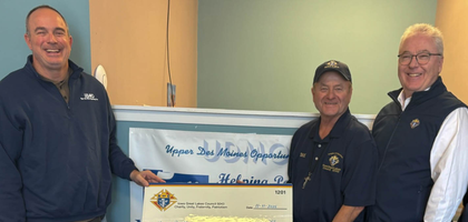 Deputy Grand Knight Johnny Klaschen (holding check, right) and other members of Iowa Great Lakes Council 5043 in Spirit Lake, Iowa, present a $500 check to Jason Petersen, outreach specialist at Upper Des Moines Opportunity, a local food pantry.