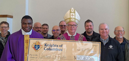 Knights from Msgr. O’Reilly Council 746 in Baraboo, Wis., present a check for more than $40,700 to Bishop Donald Hying of Madison; Father Paul Arinze (left), parochial administrator of the St. John Paul II Pastorate; and Father Piotr Janas, parochial vicar. The donation supported a $3 million capital campaign to fund mechanical and electrical repairs and upgrades at St. Joseph Church and School.
