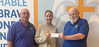 Deputy Grand Knight Daniel Costello (right) and Randall Coates of Orange Park (Fla.) Council 7399 present a $4,000 check — proceeds from the council’s spaghetti dinner — to Principal Melissa Ilski of Guardian Catholic School in Jacksonville. The funds will support several programs, including free lunches for students in need.