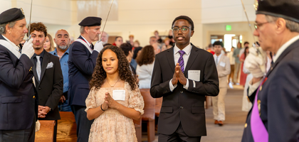 Members of Msgr. Lawrence C. Newmann Assembly 2208 in Charlotte, N.C., stand at attention as more than 90 confirmation candidates process into St. Luke Catholic Church at the start of the liturgy. Bishop Michael Martin of Charlotte presided at the Mass, concelebrated by Father Paul Gary, pastor and faithful friar.