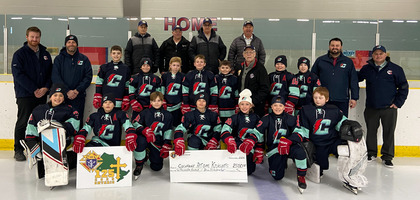 Members of Cochrane (Ontario) Council 1917 gather with players from the Atom Knights youth hockey team after presenting them with a CA$2,500 donation. The council has sponsored the team since 1972.