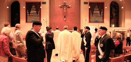 Members of Notre Dame Assembly 2144 in Farmers Branch, Texas, stand at attention during the entrance procession for a memorial Mass at Mary Immaculate Catholic Church.