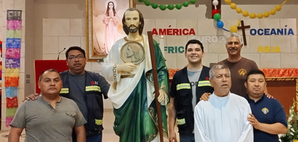 Members of Santa Filomena Council 16296 in Monterrey, Mexico Northeast, stand next to a statue of St. Jude at Santa Filomena Parish after a procession celebrating the saint. 