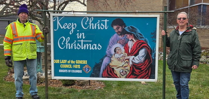 Dick Schneider (left) and Bob Caulkins of Our Lady of the Genesee Council 4812 in Rochester, N.Y., stand next to their council’s Keep Christ in Christmas sign after installing it in front of Guardian Angels Catholic Church. The council installed three similar signs, which remained on display until the first week of January, throughout the church property.