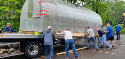 Knights from Holy Family Council 15573 in Poland, Ohio, unload a greenhouse on the grounds of Holy Family School. 