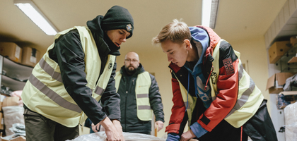 Members of Our Lady of Częstochowa Council 14004 in Radom, Poland, unpack winter jackets purchased with funds raised by Knights in Canada. 