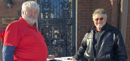 Mark Hackert (left) and Jim Tolen of Msgr. A.J. Sprigler Assembly 253 in Evansville, Ind., stand next to two collection boxes that will be placed at St. Anthony Church and St. Joseph Church. 