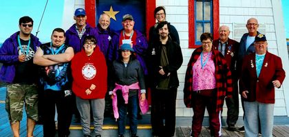 Members of Bathurst (New Brunswick) Council 1935 stand with Special Olympics athletes after the group toured the Aquarium of New Brunswick in Shippagan.