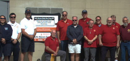 Knights from Our Lady of Sorrows Council 12149 in Valparaiso, Ind., and staff members from the South Haven Fire Department stand beside a newly installed Safe Haven Baby Box at the fire station. Father Paul Quanz, pastor of Our Lady of Sorrows Catholic Church, blessed the baby box during a dedication ceremony. The council donated $15,500 to fund the baby box.