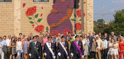 Fourth Degree Knights from Father J.A. Nieuwland Assembly 242 in South Bend, Ind., join community members in front of a new pro-life mural at the Voices for Life office building. Father Jason Freiburger, pastor of St. Monica Church in Mishawaka and a member of the assembly, blessed the mural during a dedication ceremony for which the assembly provided an honor guard. (Photo by Josef Samuel)