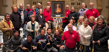 Knights from Msgr. Edward J. O’Hagan Council 16904 in Waterloo, Iowa, and parishioners of Sacred Heart Catholic Church gather around the Order’s icon of the Sacred Heart of Jesus after praying the rosary together. The council organized the event, prayed with a life-size rosary built by a brother Knight that spanned the church, to pray for an increase in vocations to the priesthood and consecrated life. The pilgrim icon remained on display in the church for all Masses over a weekend.
