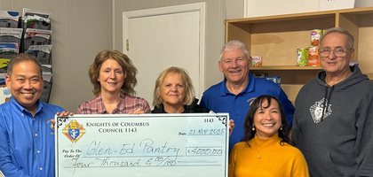Knights from Edwardsville (Ill.) Council 1143 and family members present a $4,000 check to members of the board of directors of Glen-Ed Pantry. The council organized a food and household item drive for the pantry at St. Boniface Catholic Church, collecting more than 1,100 pounds of items. This drive was in addition to the two that the Knights usually hold each year.
